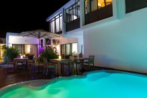 a villa with a swimming pool at night at Villa Alizée Boutique Hotel - Idéal Couples & Pros - Rooftop in Port Louis