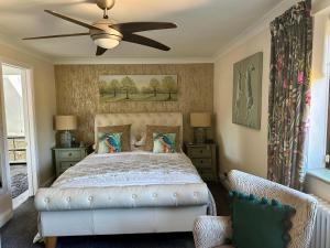 a bedroom with a bed and a ceiling fan at Beechwood B and B in Halland