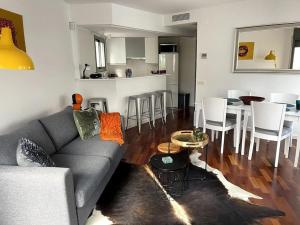 a living room with a couch and a table and chairs at Pure Bliss Apartment Sitges in Sitges