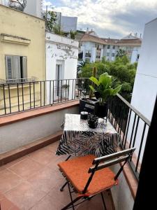 a balcony with a bench and a table on a balcony at Pure Bliss Apartment Sitges in Sitges