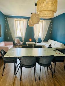 a living room with a table and chairs and a couch at The Blue House in Larnaka