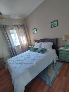 a bedroom with a large bed with two pillows on it at Alameda Residence in Tomar