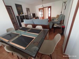a living room with a glass table and chairs at CONCHA DEL MAR PMCM in Torre del Mar