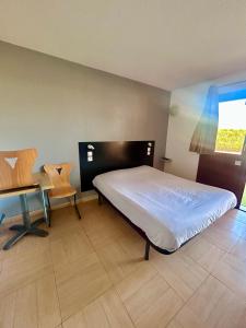 Postel nebo postele na pokoji v ubytování Hôtel Acajou
