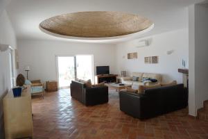 a living room with couches and a ceiling at Goldra Cozy Villa with private pool in Valados