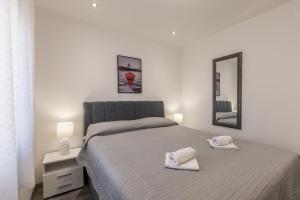 a bedroom with a bed with two towels on it at Apartments Petra in Bol