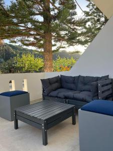 a living room with a couch and a tree at Manolis&Xenia in Kefalos