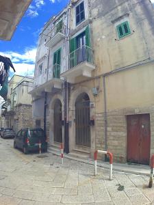 a building with a car parked in front of it at PERGOLA in Molfetta