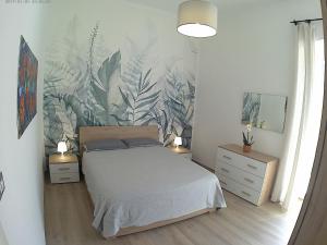 a bedroom with a bed and a plant wall at PERGOLA in Molfetta