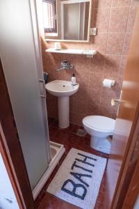 a small bathroom with a toilet and a sink at Long View Apartment, Korčula in Korčula