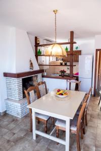 a kitchen and dining room with a table and a fireplace at Long View Apartment, Korčula in Korčula