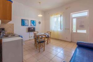 a kitchen and dining room with a table and chairs at One-Bedroom Apartment Crikvenica 22 in Crikvenica