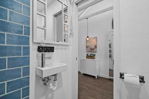 a bathroom with a sink and a mirror at 1 Mi to Lewisville Lake Fun Cozy Couples Retreat in Lake Dallas +17 photos