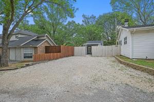 a driveway with a fence and a house at 1 Mi to Lewisville Lake Fun Cozy Couples Retreat in Lake Dallas