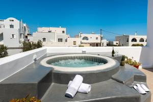 a hot tub on the roof of a house at Aerenia Luxury Suites in Karterados