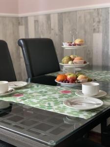 a table with plates and bowls of food on it at Hof Görrespesch-Ferien im Herzen der Schneifel in Schlausenbach +17 photos