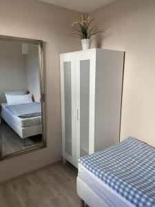 a bedroom with a mirror and a bed and a dresser at Hof Görrespesch-Ferien im Herzen der Schneifel in Schlausenbach