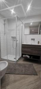 a bathroom with a shower and a toilet and a sink at Holiday House in Nardò