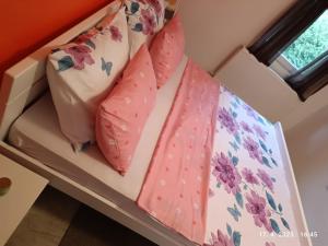 a bed with pink ties on top of it at Villa Nana in Kulen Vakuf +56 photos