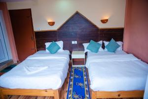 Una cama o camas en una habitación de Hotel Olympus Pokhara