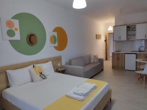 a bedroom with a bed and a living room at Iris Apartments Ksamil in Ksamil