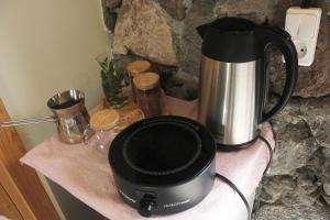 a microwave sitting on a counter next to a coffee maker at Zove Rural Cottage with garden views in Kʼarashamb