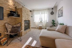 a living room with a couch and a brick wall at Holiday home in Crikvenica 5239 in Dramalj
