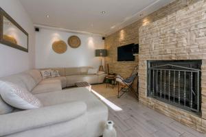 a living room with a couch and a fireplace at Holiday home in Crikvenica 5239 in Dramalj