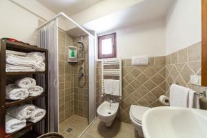 a bathroom with a toilet and a sink and a shower at La corte di Ercole in Alberobello +16 photos