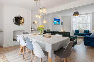 a dining room and living room with a table and chairs at 9 Riverside in Sidmouth