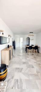 a living room with white walls and a large tile floor at Mijas Holiday in Fuengirola