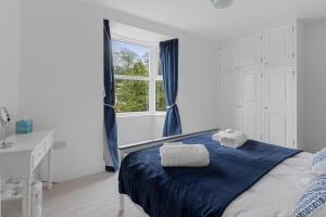 a bedroom with a bed with towels on it at 9 Riverside in Sidmouth