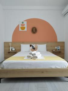 a bedroom with a large bed with an orange headboard at Iris Apartments Ksamil in Ksamil