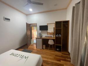 Camera con letto, scrivania e cucina. di Mandhoo Inn a Mandhoo