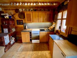 a kitchen with wooden cabinets and a stove top oven at Woodenhouse Maramures in Vişeu de Sus
