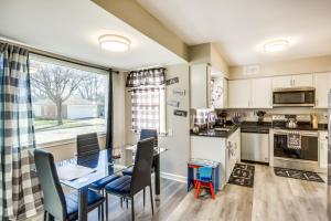 a kitchen with a dining table and chairs and a window at 7 Mi to Lake Michigan Milwaukee Vacation Rental in Milwaukee