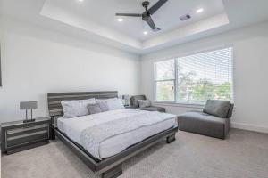 a bedroom with a bed and a chair and a window at Your home away from home in Houston