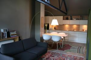 a living room with a couch and a table at B&B La Chambre d'à Côté in Aische-en-Refail