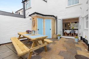a wooden picnic table on the patio of a house at 9 Riverside in Sidmouth