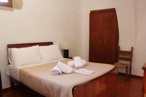A bed or beds in a room at Evanthea Residence