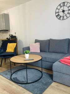 a living room with a couch and a table at Nowy Apartament in Świnoujście