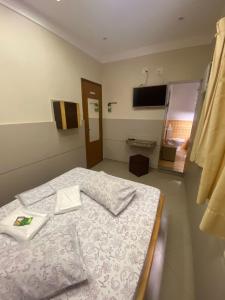 a bedroom with a bed with a tray on it at Namorata Expo Inn in São Paulo