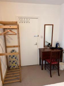 a bedroom with a desk and a bunk bed and a mirror at Lovely - 1 Bedroom Flat in Hastings Town Centre in Hastings