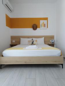 sypialnia z dużym łóżkiem z drewnianym zagłówkiem w obiekcie Iris Apartments Ksamil w mieście Ksamil