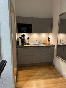 a kitchen with a sink and a microwave at Ferienwohnung - Schweriner Altstadt - FeWo 6 in Schwerin