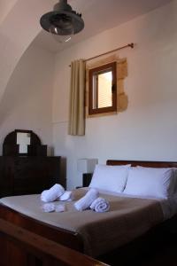 A bed or beds in a room at Evanthea Residence