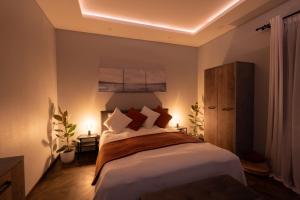 a bedroom with a large bed with pillows at Piejūras māja skandināvu stilā! Seaside scandi house! in Lapmežciems +56 photos