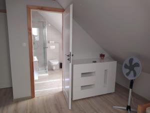 a bathroom with a shower and a toilet and a fan at u Tymka in Iława