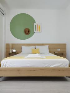1 dormitorio con 1 cama grande y espejo verde en Iris Apartments Ksamil en Ksamil