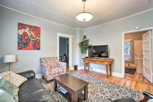 a living room with a couch and a table at Historic Redstone with Large Backyard, Walk To CSU! in Fort Collins